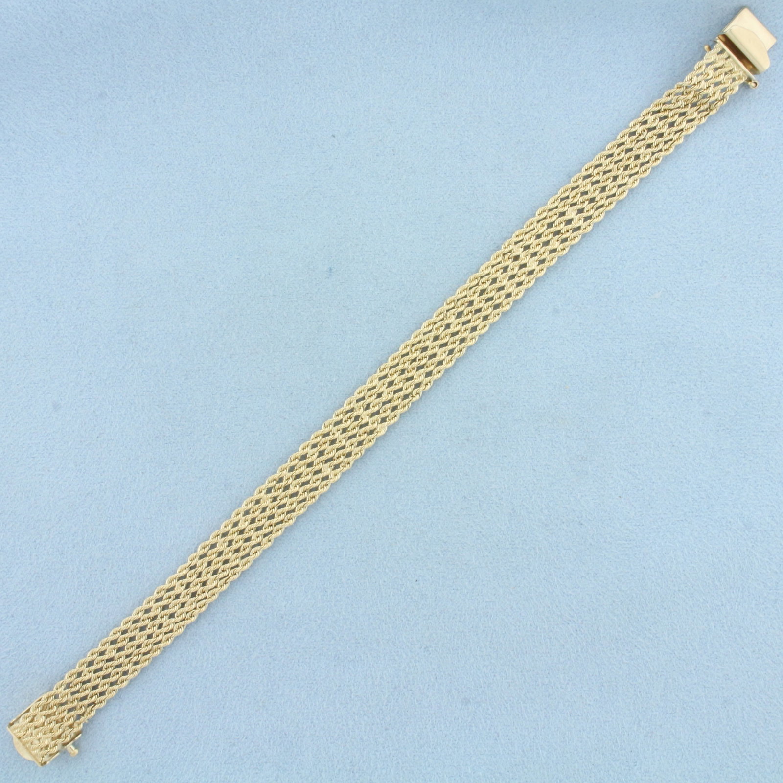 Wide Five Strand Rope Bracelet in 14k Yellow Gold: In 14k Yellow Gold. 6 7/8 inches long. 3/8 inch wide. Concealed slide clasp with safety latch. 13.2g.