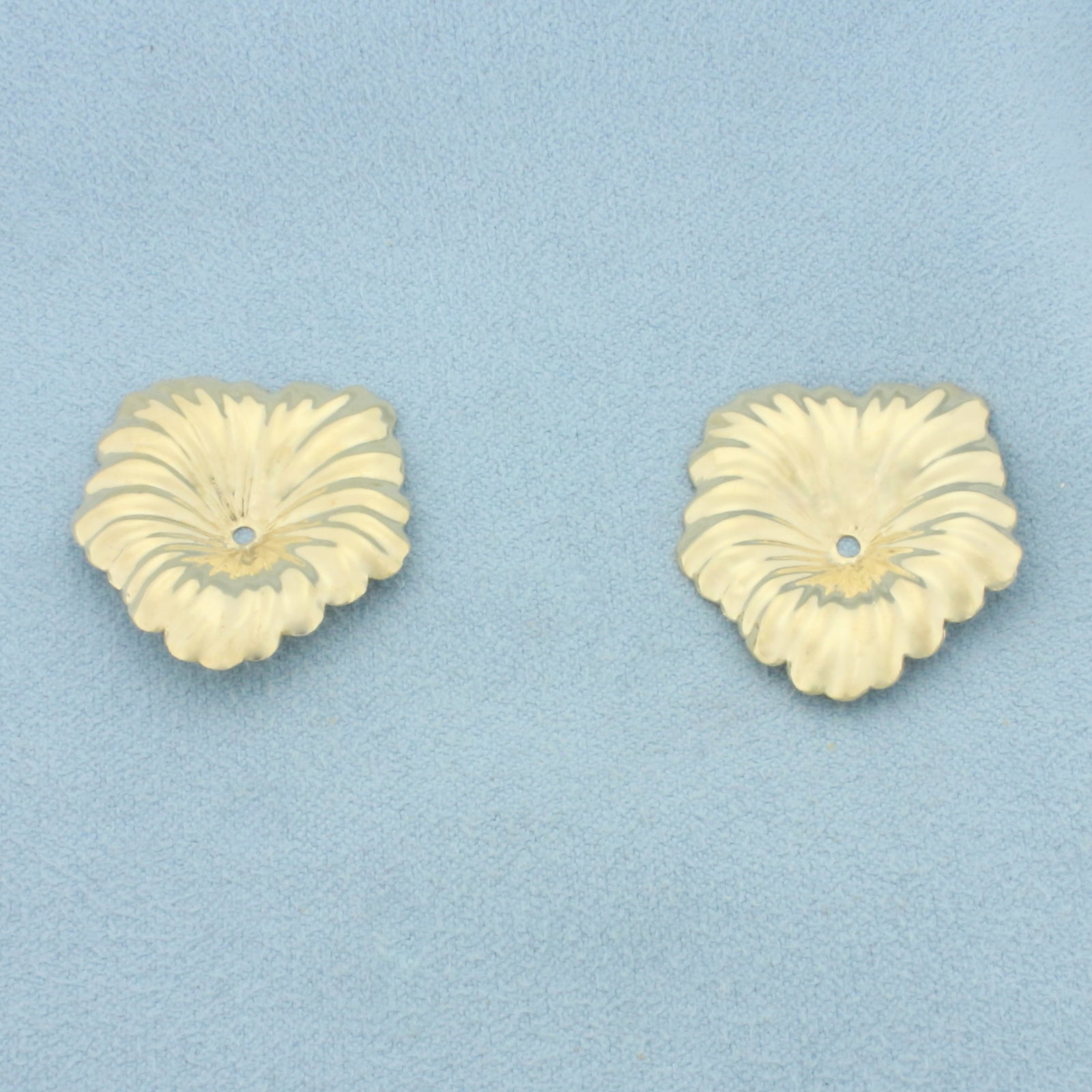Leaf Stud Earring Jacket Enhancers in 14k Yellow Gold: In 14k Yellow Gold. 1 inch long. 7/8 inch wide. 1.7g.