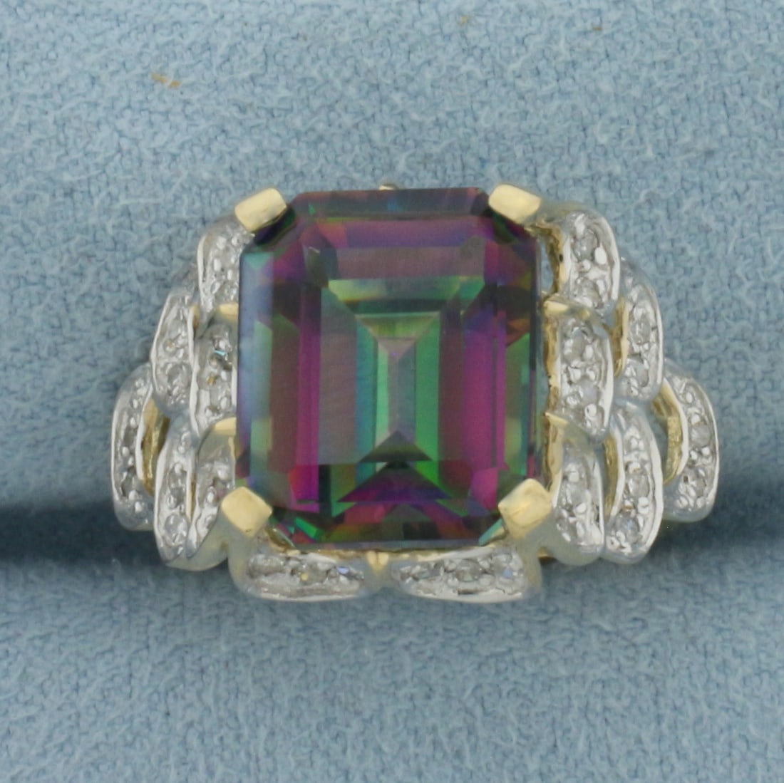 Mystic Topaz and Diamond Ring in 10K Yellow Gold: In 10k yellow gold. Contains one high quality emerald cut Mystic Topaz, 12x10mm, approximately 5 carats, with vibrant color and excellent clarity. Accented with 38 high quality 1/2pt diamonds. Size 7.