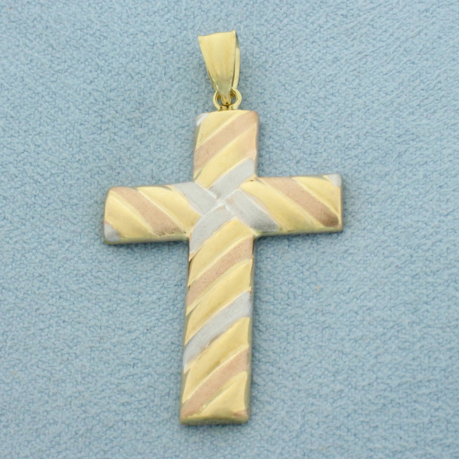 Tri-Color Cross Pendant in 10k Yellow, White, and Rose Gold: In 10k Yellow, White, and Rose Gold. 1 1/4 inch long. 7/8 inch wide. 1.8g.