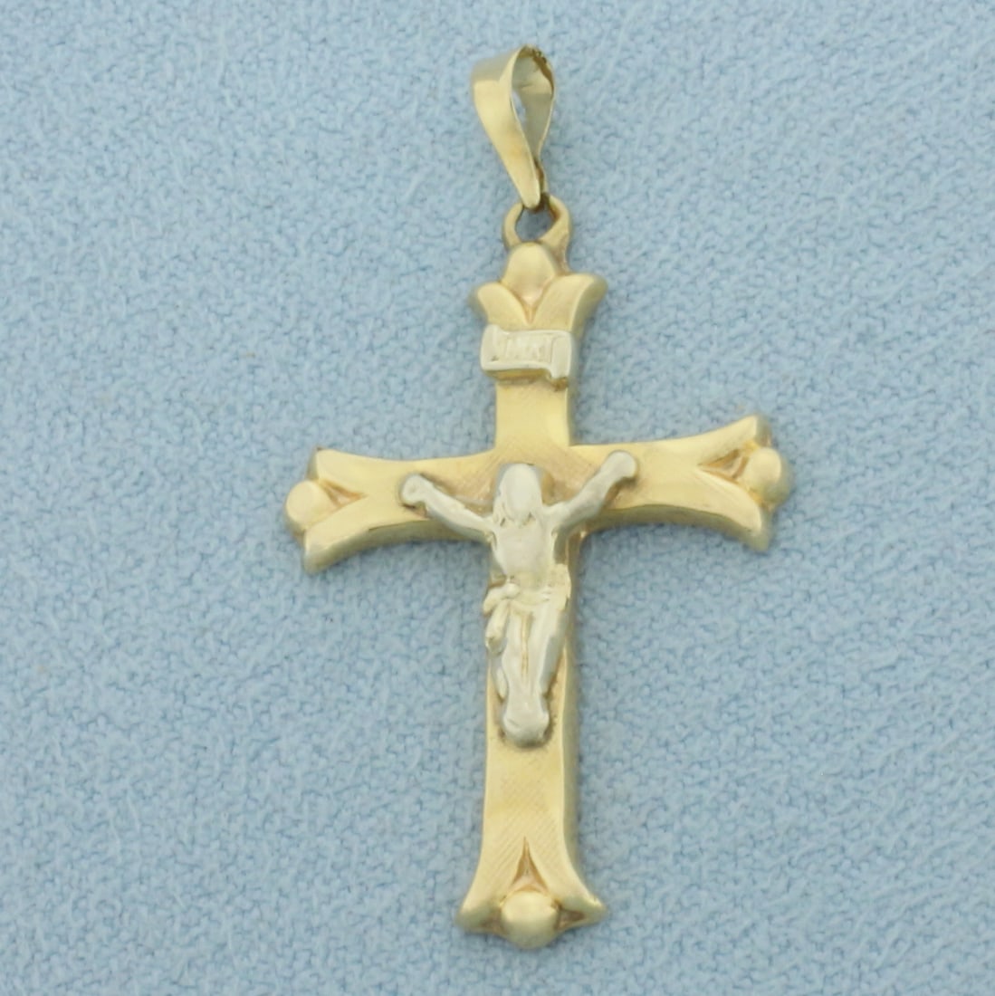 Two-Tone Crucifix Cross Pendant in 14k Yellow and White Gold: In 14k Yellow and White Gold. 1 1/8 inch long. 5/8 inch wide. 1.0g.