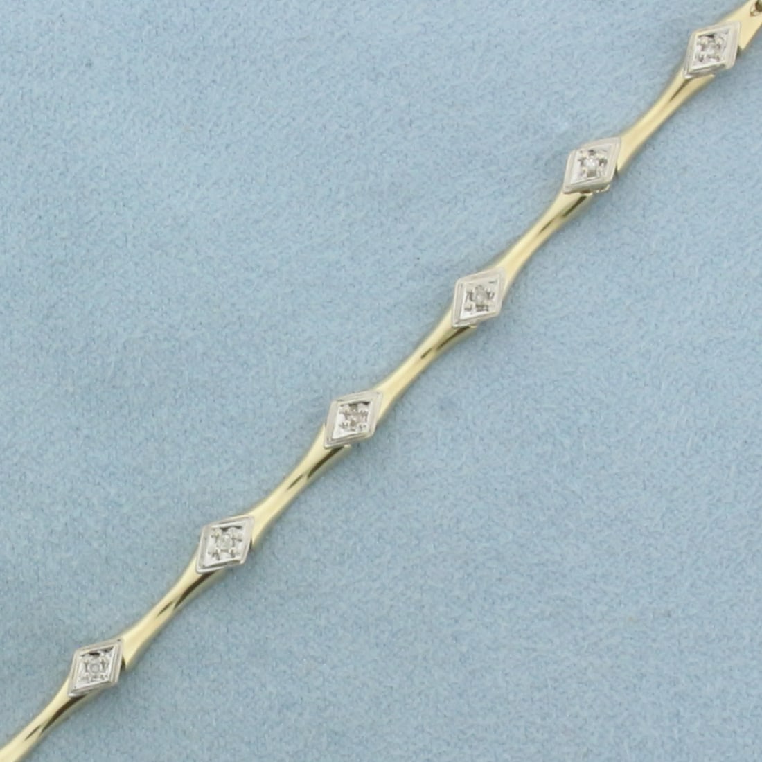Diamond Bracelet in 10k Yellow Gold: In 10k Yellow Gold. 7 1/4 inches long. 4.2mm wide. Contains 13 high quality .01ct diamonds, SI clarity/H color. Concealed clasp with safety latch. 5.1g.