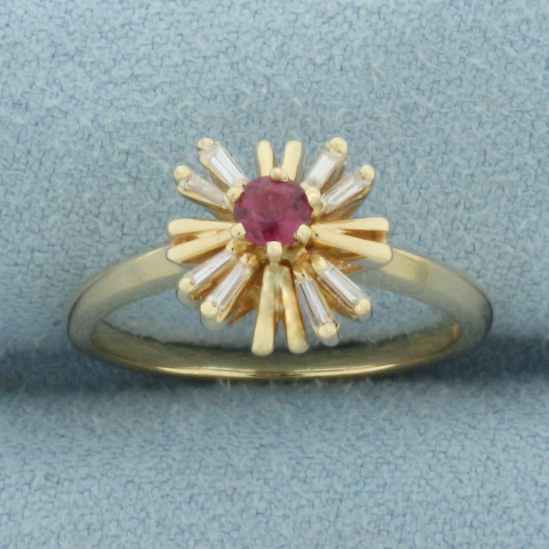Ruby and Baguette Diamond Ring in 14k Yellow Gold: In 14k Yellow Gold. Contains one 3.3mm high quality natural Ruby gemstone with rich color and excellent clarity. Also contains eight 5mm high quality baguette diamonds, SI clarity/H color. 10mm wide a