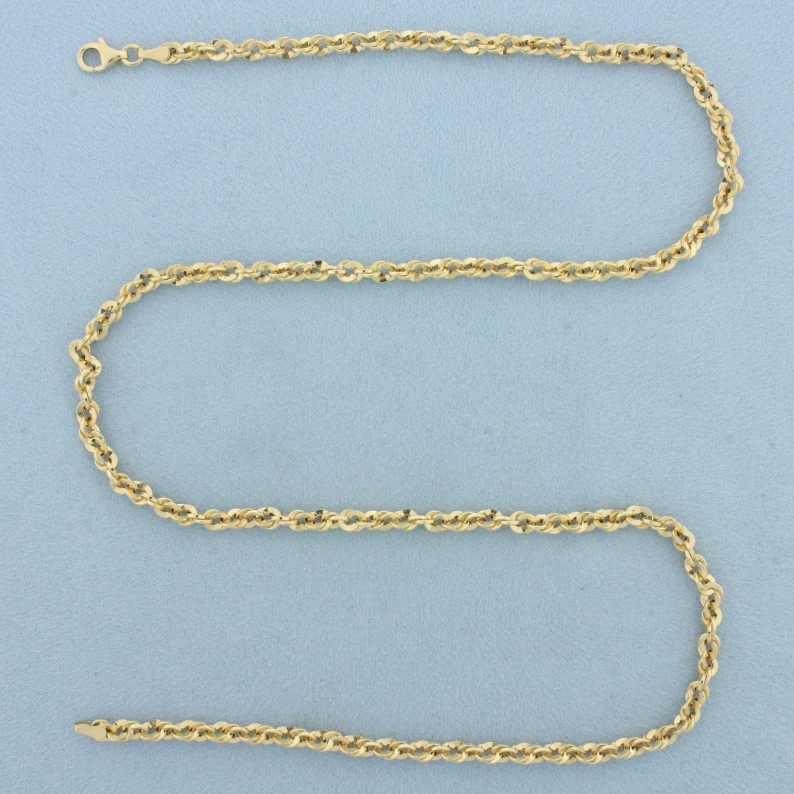 20 Inch Italian Twisting Curb Link Chain Necklace in 14k Yellow Gold: In 14k Yellow Gold. 20 inches long. 3.75mm wide. Italian made. Lobster clasp. 5.1g.