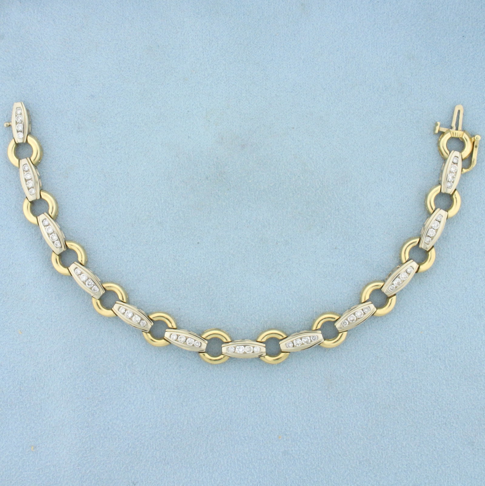 Diamond Cable Link Tennis Bracelet in 14K Yellow and White Gold: In 14K Yellow and White Gold. Contains forty eight high quality Diamonds, 1.5ct TW, SI clarity/I color. 7 1/2 inches long, 9.3mm wide. Safety clasp. 19.3g.