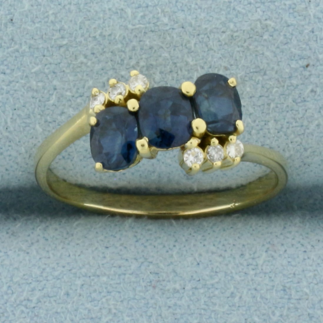 Sapphire and Diamond Ring in 14k Yellow Gold: In 14k Yellow Gold. Contains three high quality natural AAA quality Sapphire gemstones, 1ct TW, with very intense color and excellent clarity. Also contains six .01ct diamonds, SI clarity/G color.
