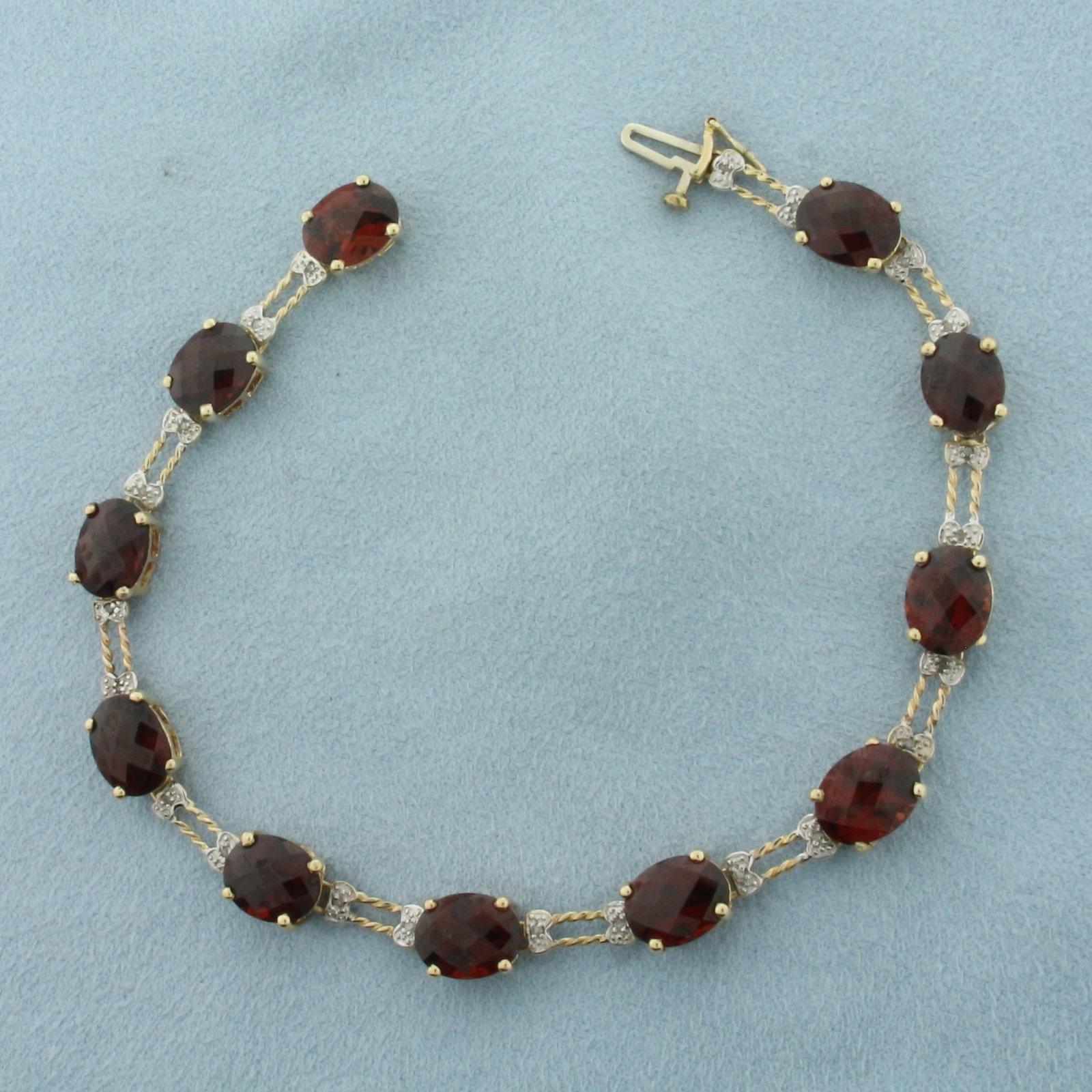 Fancy Checkerboard Cut Garnet And Diamond Bracelet in 10k Yellow Gold: In 10k yellow gold. 8 Inches long. Contains 11 high quality natural fancy checkerboard oval cut Garnet gemstones, 9x7mm each, with vibrant color and excellent clarity. Accented with 22 high quality na
