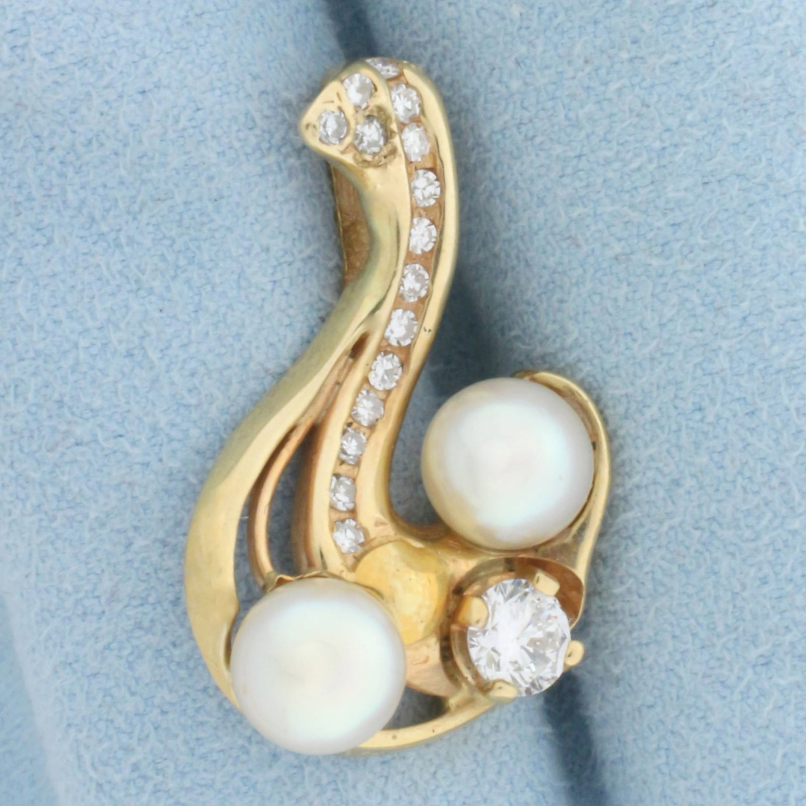 Diamond and Akoya Pearl Pendant in 14K Yellow Gold: In 14K Yellow Gold. Contains two high quality natural 6.8mm Cultured Akoya Pearls with mirror like luster. Also contains one high quality 1/3ct and fifteen .02ct round Diamonds, VS clarity/F color. 1 