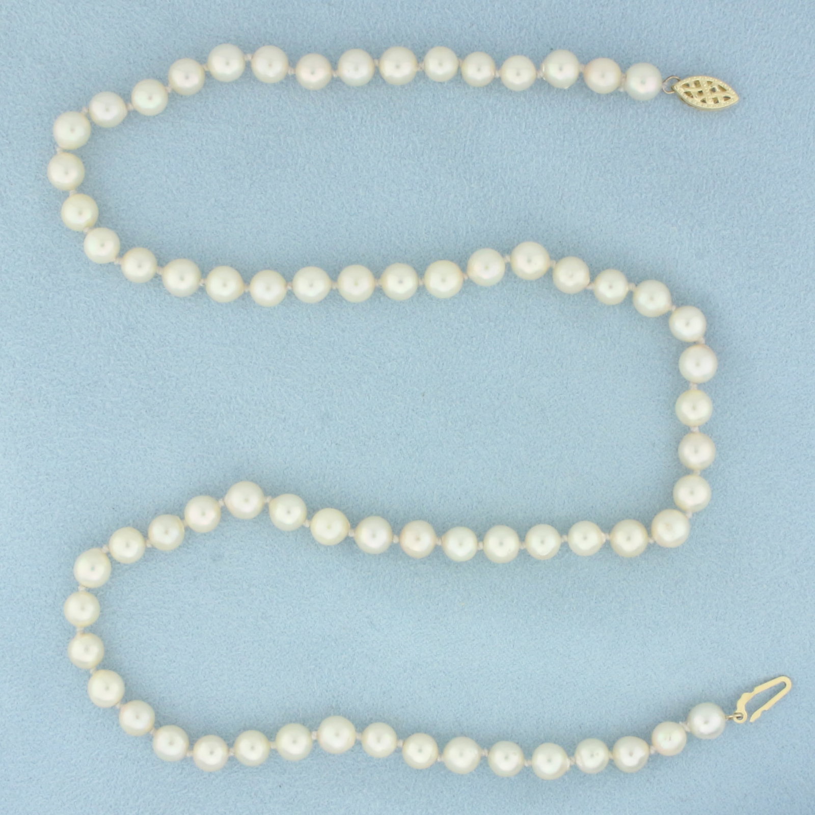 Cultured Akoya Pearl Strand Necklace with 14k Yellow Gold Filigree Clasp: In 14k Yellow Gold Filigree Locking Clasp. Contains 6mm high quality cultured Akoya pearls with high luster. 17.5 inches long. Hand-knotted, newly restrung.