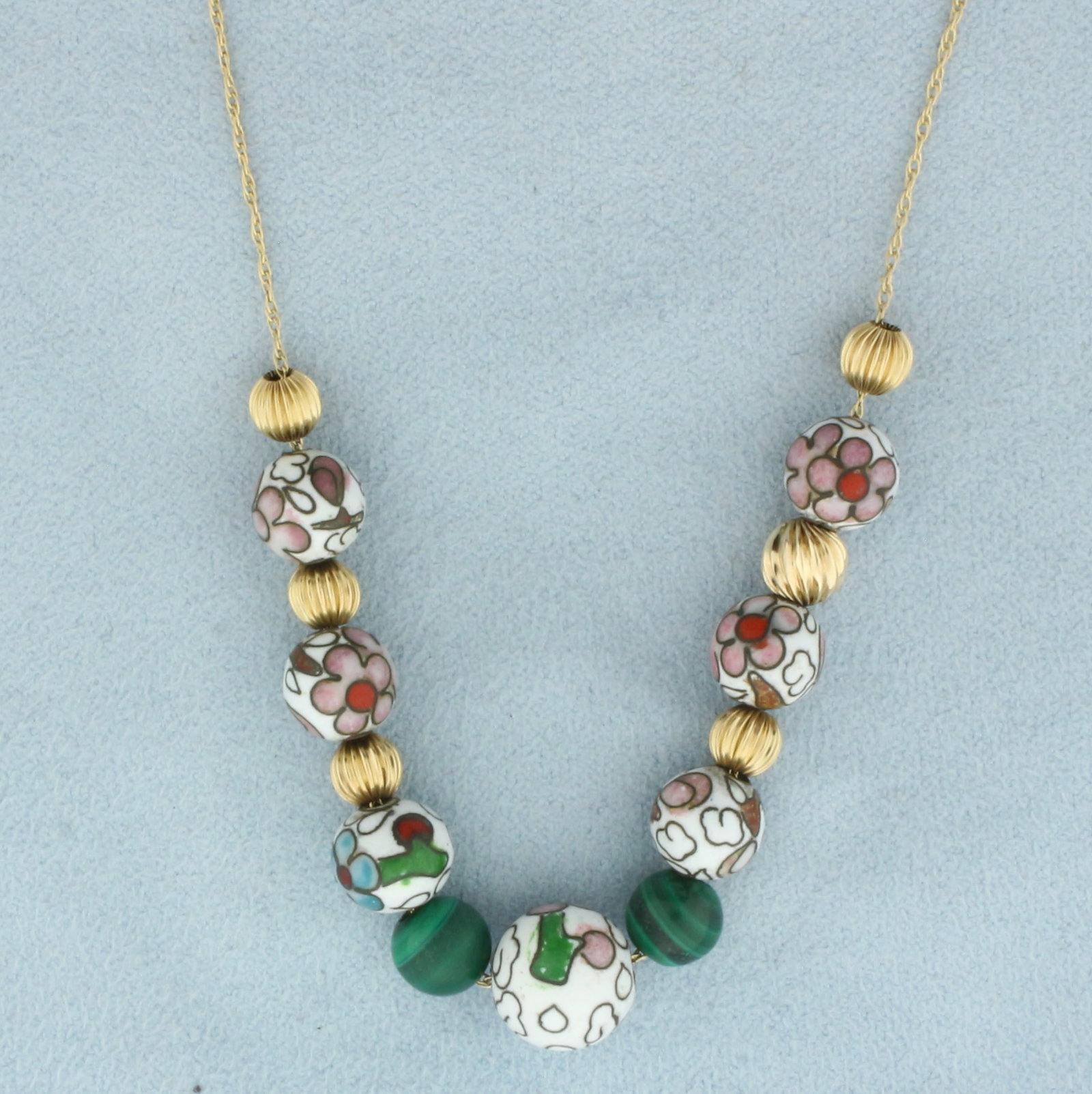 Malachite and Gold Bead Add a Bead Necklace in 14k Yellow Gold: In 14k Yellow Gold. Contains two 6.8mm high quality malachite and seven 8 to10mm high quality flower design beads. Also contains six 6mm gold beads. 26 inches long. 0.7mm wide. 9.5g.