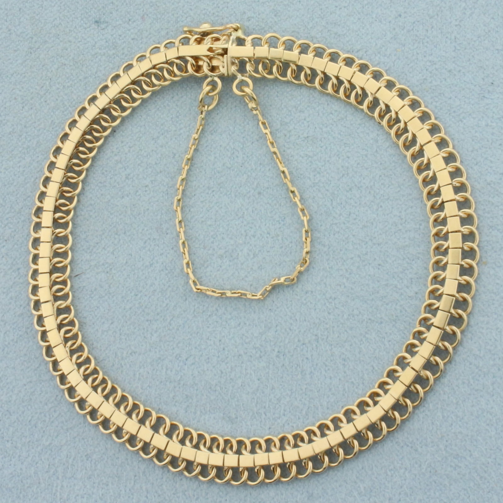 Articulated Mesh Link Bracelet in 10k Yellow Gold: In 10k Yellow Gold. 7 1/4 inches long. 6.3mm wide. Concealed slide clasp with safety latch and safety chain. 9.1g.