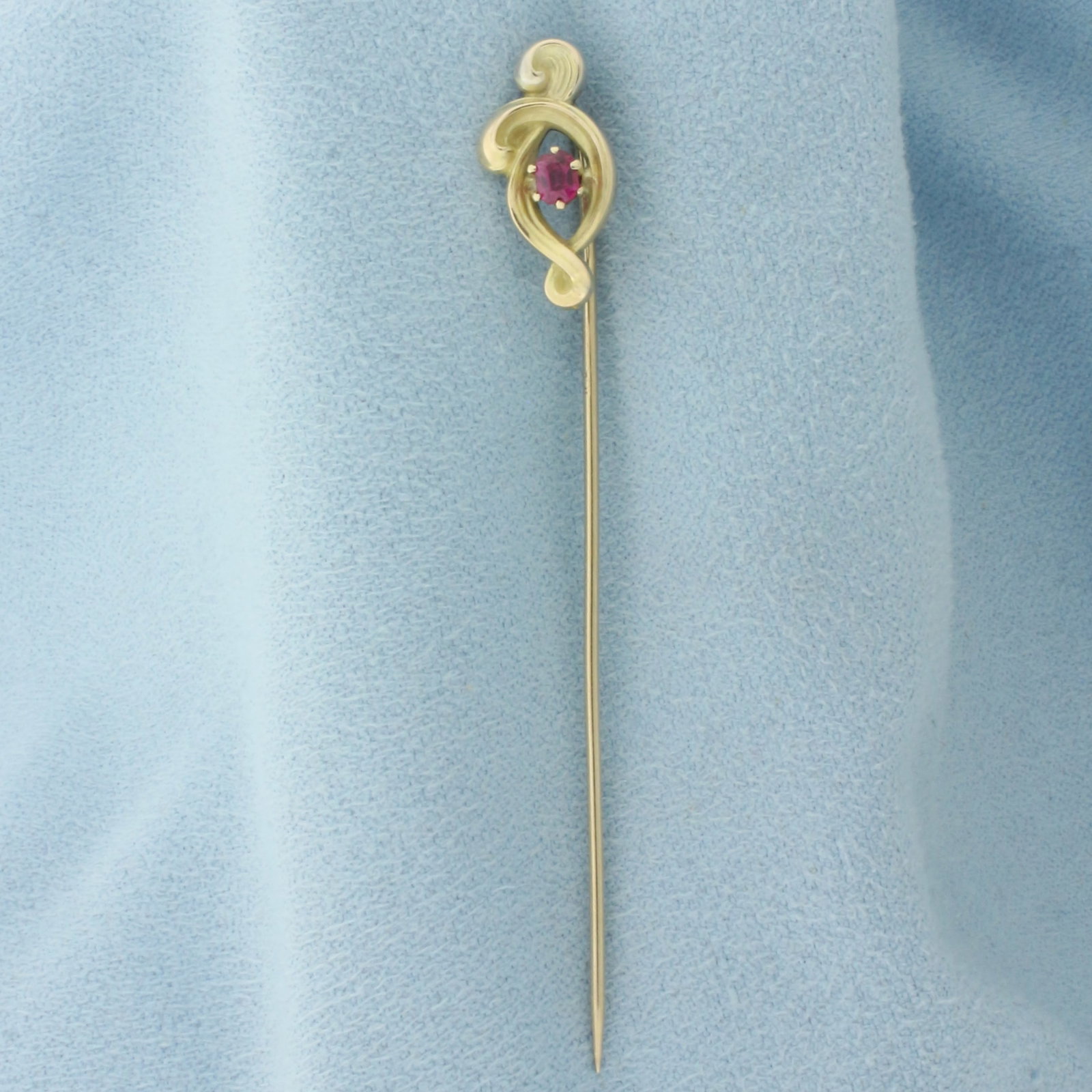 Ruby Stick Pin in 10k Yellow Gold: In 10k Yellow Gold. Contains one 3.5x3mm high quality natural Ruby gemstone, with vibrant color and excellent clarity. 2.5 inches long. 3/8 inch wide. 1.5g.