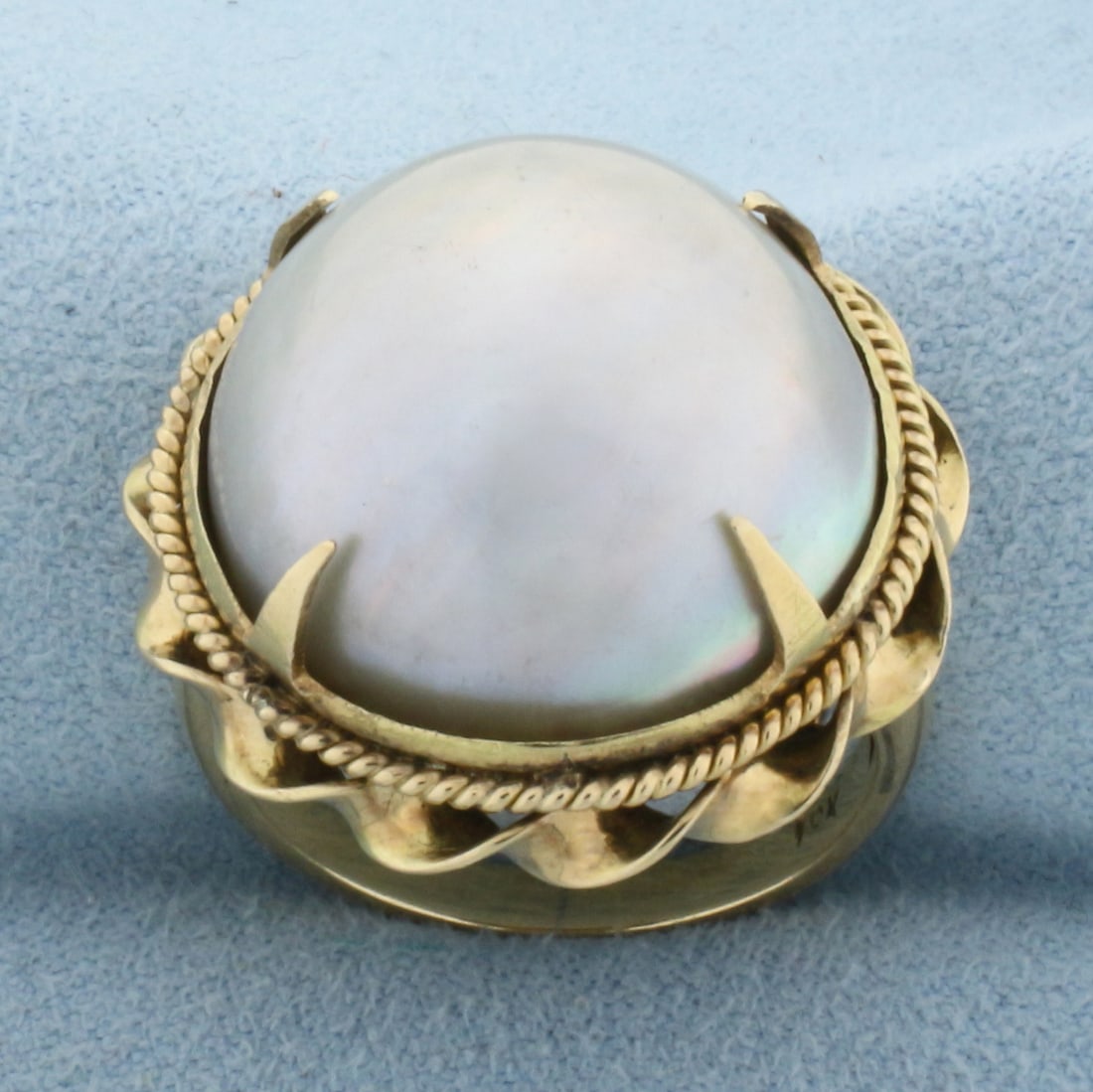 Vintage Mother of Pearl Statement Ring in 10K Yellow Gold: In 10K Yellow Gold. Contains one high quality natural significant 20mm Mabe pearl gemstone with beautiful silver color with iridescent undertones. Size 7. 9.3g.