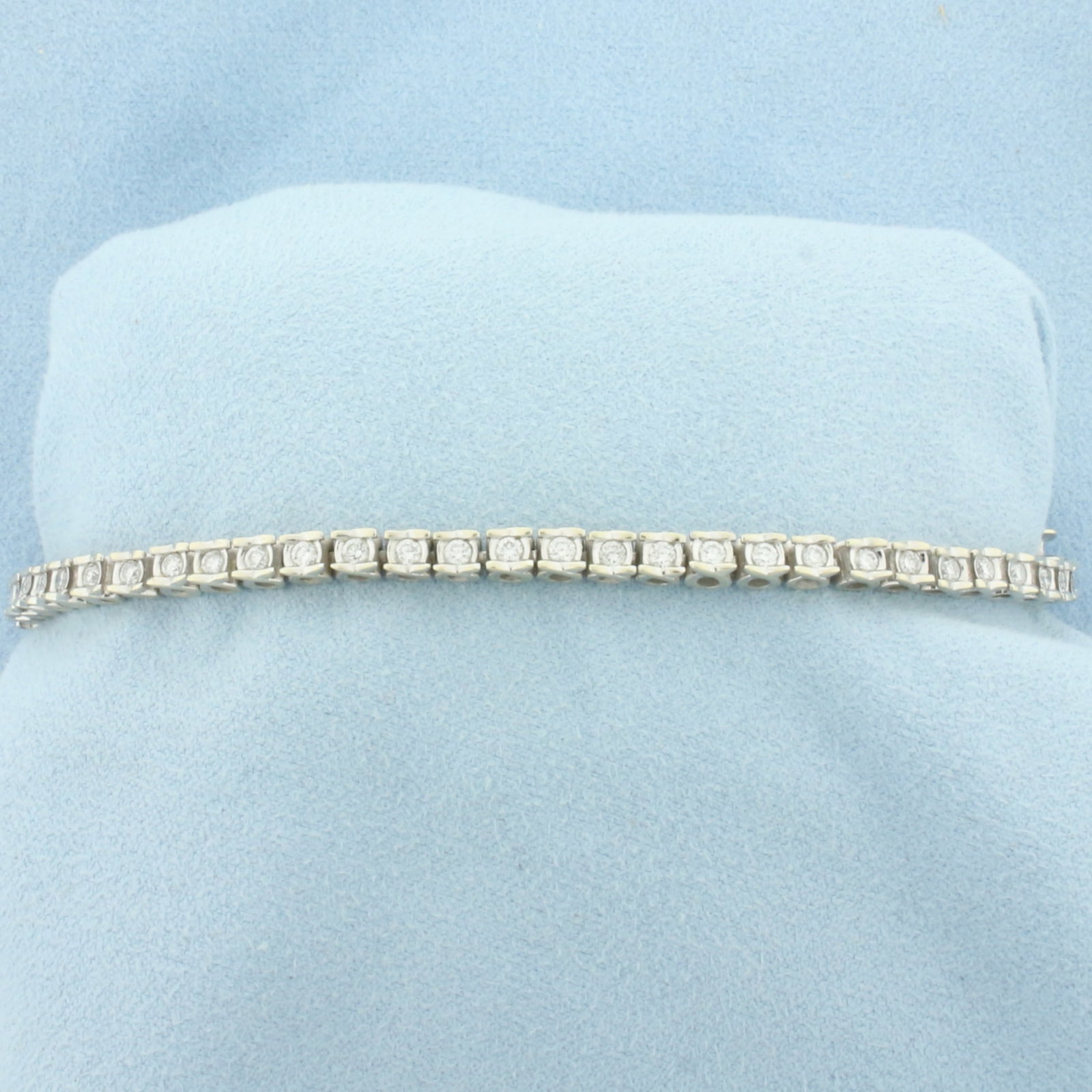 Certified 2ct Diamond Tennis Bracelet in 14k White Gold: In 14k White Gold. Contains forty-eight high quality diamonds, 2ct TW, H-I color/I1 clarity. 7 1/8 inch long. 3.5mm wide. Includes IGI Certificate #497212. Concealed slide clasp with underswing