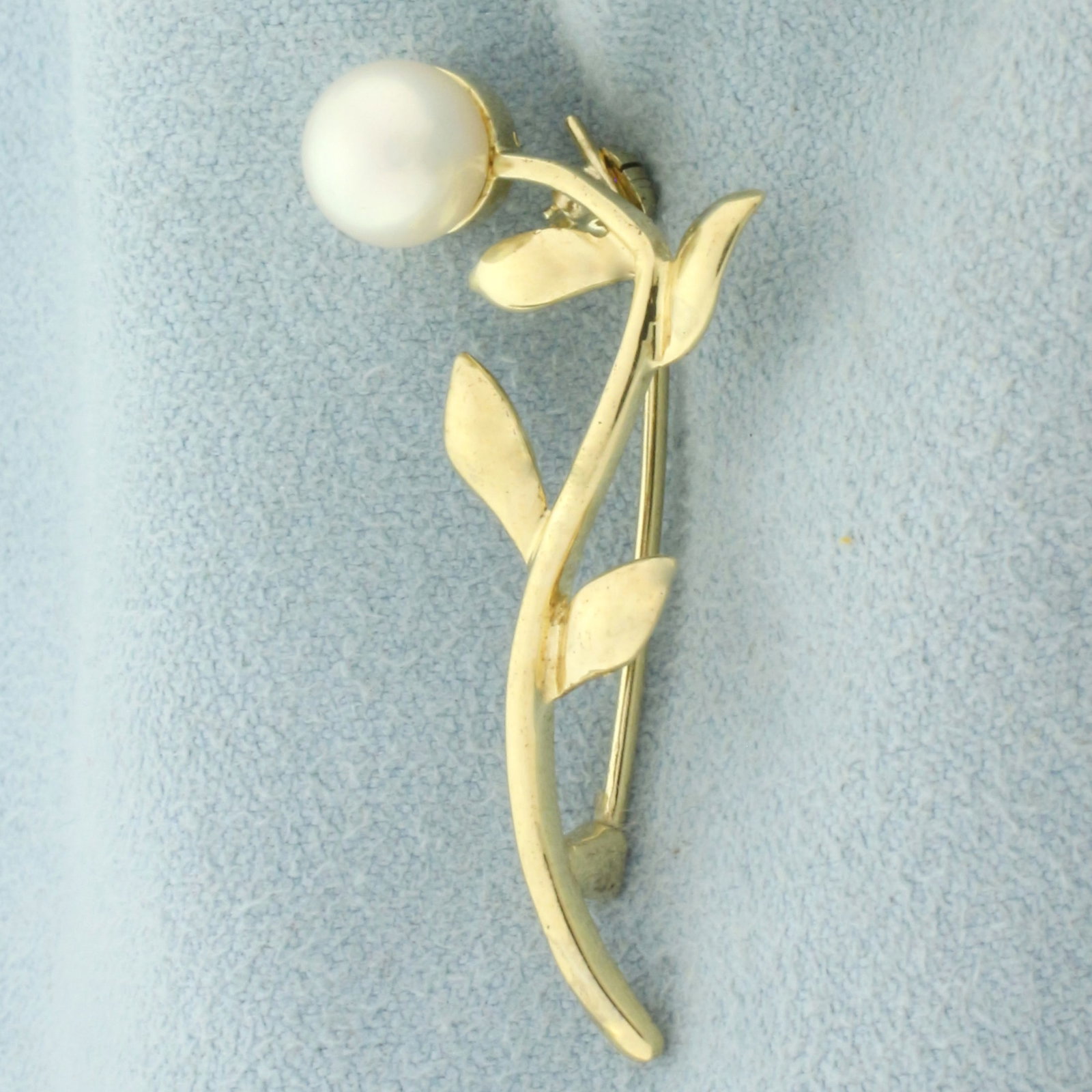 Cultured Akoya Pearl Flower Pin Brooch in 14k Yellow Gold: In 14k yellow gold. Contains one high quality 6.75mm cultured Akoya pearl with high luster. 1.5 inches long and 5/8 inches wide. 2.6g.