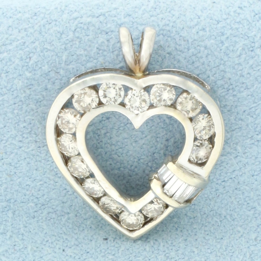 Diamond Heart Pendant in 14k White Gold: In 14k White Gold. Contains fourteen round and four baguette high quality diamonds, 3/4ct TW, J color/I clarity. 3/4 inch long. 5/8 inch wide. 2.8g.