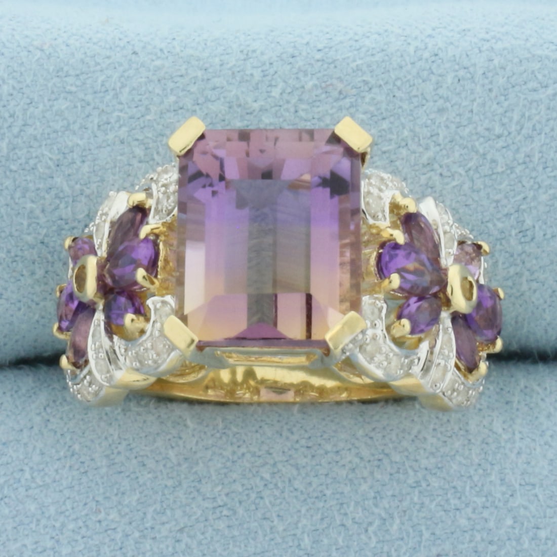 Ametrine and Diamond Statement Ring in 10k Yellow Gold: In 10k Yellow Gold. Contains one 12x10mm emerald cut natural Ametrine gemstone, approximately 5cts, with bright color and excellent clarity. Also contains four 5x3mm pear and eight 4x2mm marquise high