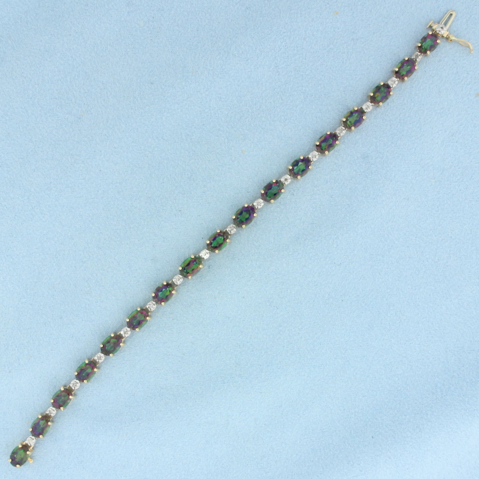 Mystic Topaz and Diamond Tennis Bracelet in 14k Yellow Gold: In 14k Yellow Gold. Contains seventeen 7mm high quality Mystic Topaz gemstones, approximately 17ct TW, with intense color and excellent clarity. Also contains seventeen high quality 1/2pt diamonds. 7 