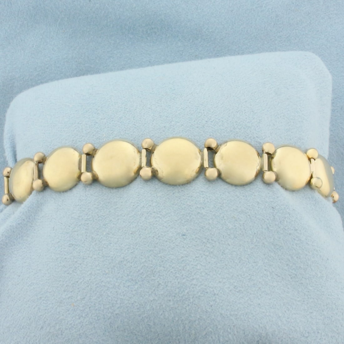 Vintage Button Design Bracelet in 14K Yellow Gold: In 14k yellow gold. 6 inches long by 11mm wide. Slide clasp with safety chain. 12.3g.