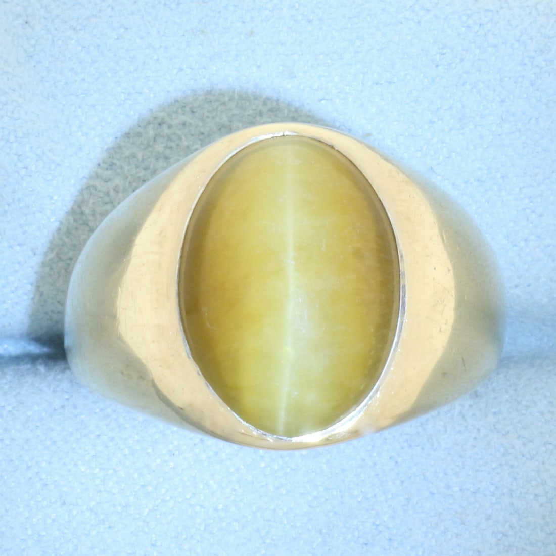 Mens Cat's Eye Ring in 10k Yellow Gold: In 10k yellow gold. Contains one high quality 15mm natural cats eye gemstone with very distinct "eye" under light. 17mm wide at center. Size: 12.5. 10.5g.
