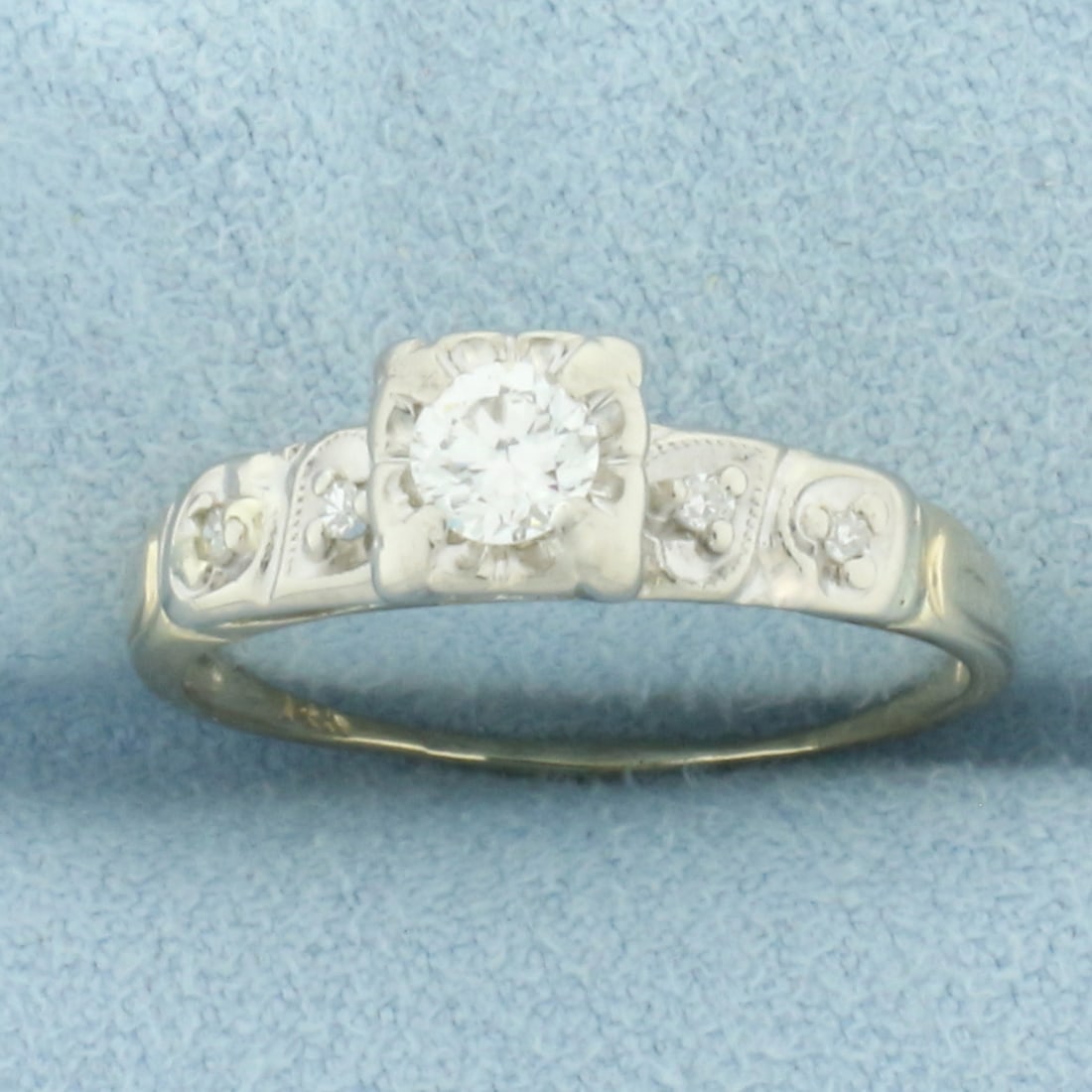 Vintage Diamond Engagement Ring in 14k Yellow and White Gold: In 14k yellow and white gold. Contains one high quality 1/4ct round brilliant diamond, VS clarity/H color, great cut for added brilliance. Also contains four 1/2pt diamonds in shank of similar high qu