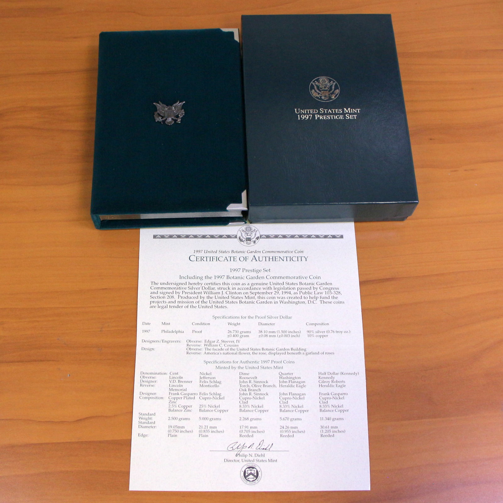 US Mint Botanic Garden Prestige Coin Set OGP: 1997 United States Mint Botanic Garden Prestige Set with one 1997 90% Silver Commemorative Silver Dollar. Set in original packaging and contains certificate of authenticity.