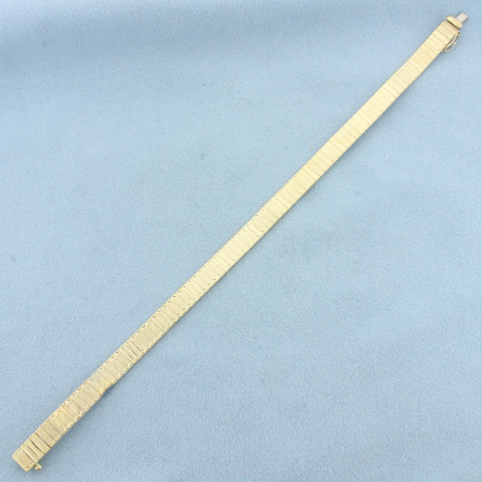 Diamond Cut Omega Bracelet in 14k Yellow Gold: In 14k Yellow Gold. 7 1/8 inches long. 1/4 inch wide. Italian made. Diamond cut pattern for unique look. Concealed slide clasp with safety clasp. 12.7g.