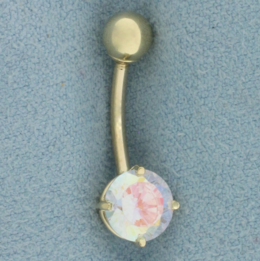 White Mystic Topaz Belly Ring in 14k Yellow Gold: In 14k Yellow Gold. Contains one 7mm high quality White Mystic Topaz gemstone. 1.2g.