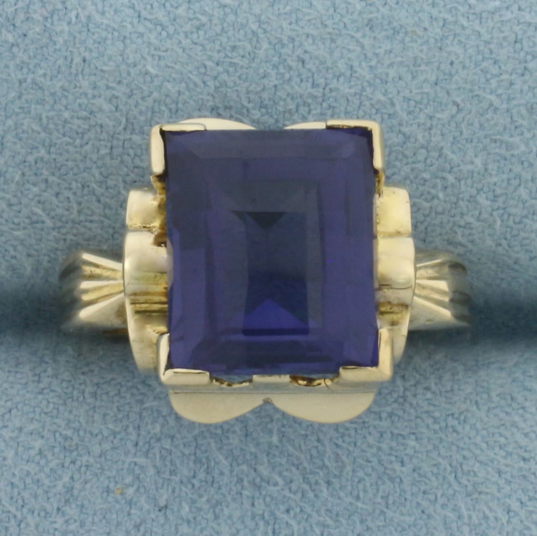 Color Change Lab Sapphire Ring in 14k Yellow Gold: In 14k Yellow Gold. Contains one 12x10mm high quality checkerboard cut Lab Sapphire gemstone with strong color shift from blue/purple to pink/red. Excellent clarity. Size 6.75. 4.9g.