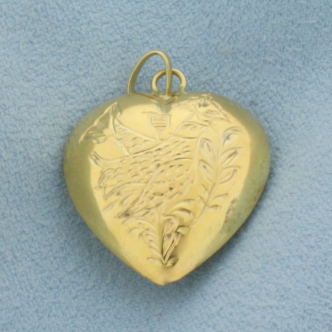 Etched Bird 3-D Heart Pendant or Charm in 14k Yellow Gold: In 14k Yellow Gold. 1 inch long. 3/4 inch wide. 3.4g.