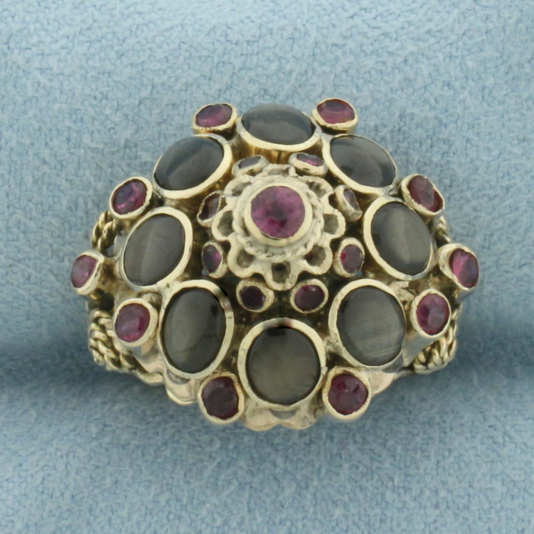 Ruby and Black Star Sapphire Thai Princess Ring in 14K Yellow Gold: In 14K Yellow Gold. 17mm wide at top of ring. Contains eight high quality natural 5mm Black Star Sapphires with distinct "star" under light. Also contains one 3mm, ten 2.25mm, and eight 1.5mm high qua