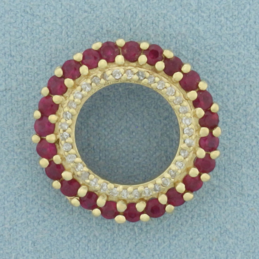 Ruby and Diamond Circle Pendant in 14k Yellow Gold: In 14k Yellow Gold. Contains twenty-three 2.5mm high quality natural Ruby gemstones with vibrant color. Also contains thirty-five high quality 1/2pt diamonds. 21mm diameter. 3.7g.