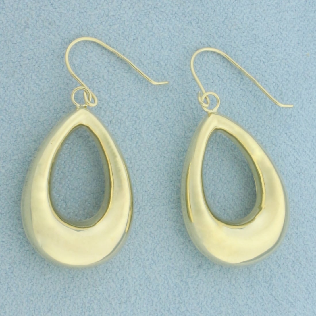 Teardrop Dangle Earrings in 10k Yellow Gold: In 10k Yellow Gold. 7/8 inch long. 5/8 inch wide. Ear hooks. 1.8g.