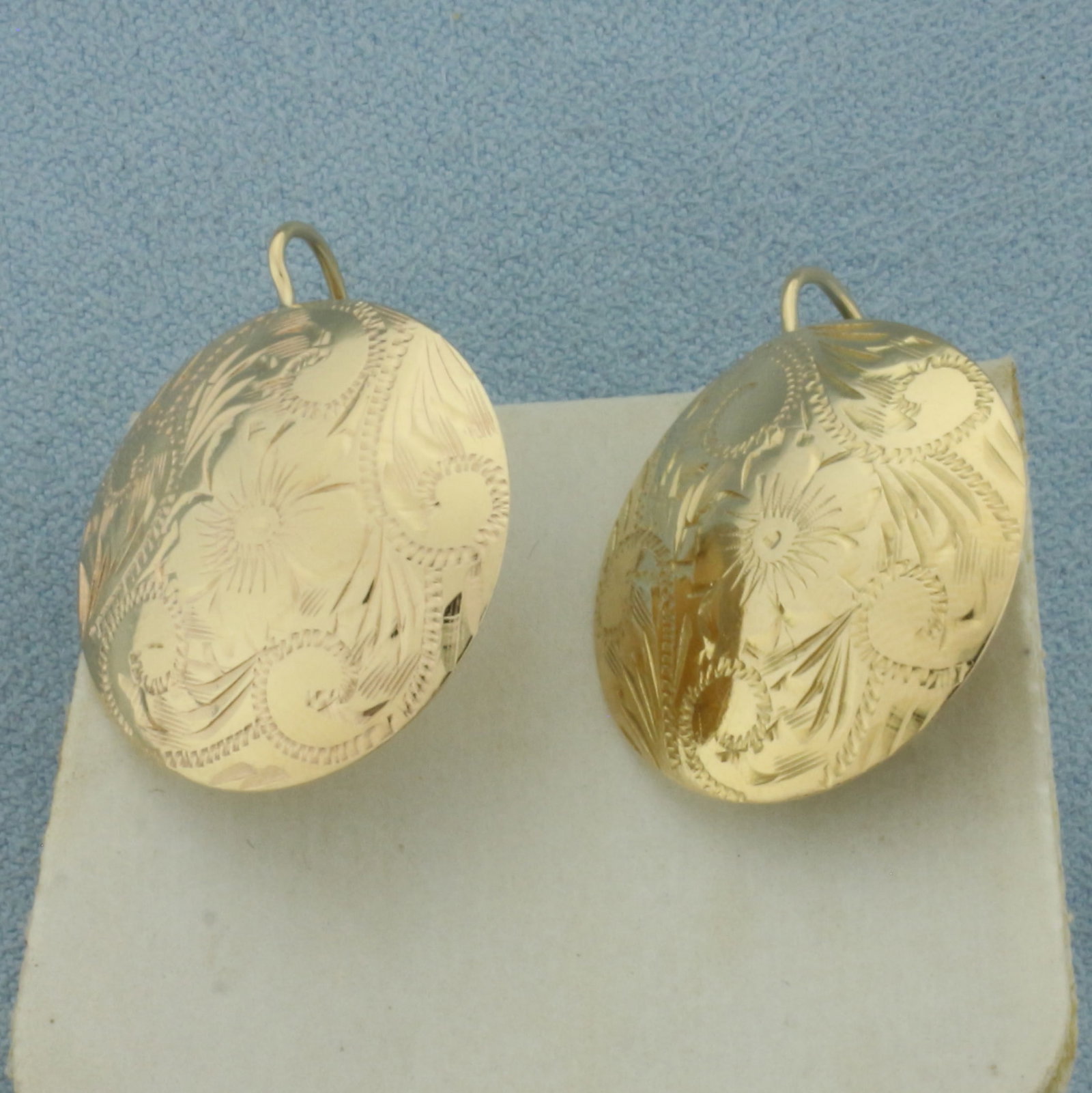 Flower Design Etched Earrings in 14k Yellow Gold: In 14k Yellow Gold. 1 inch long. 3/4 inch wide. French hook backs. 3.3g.