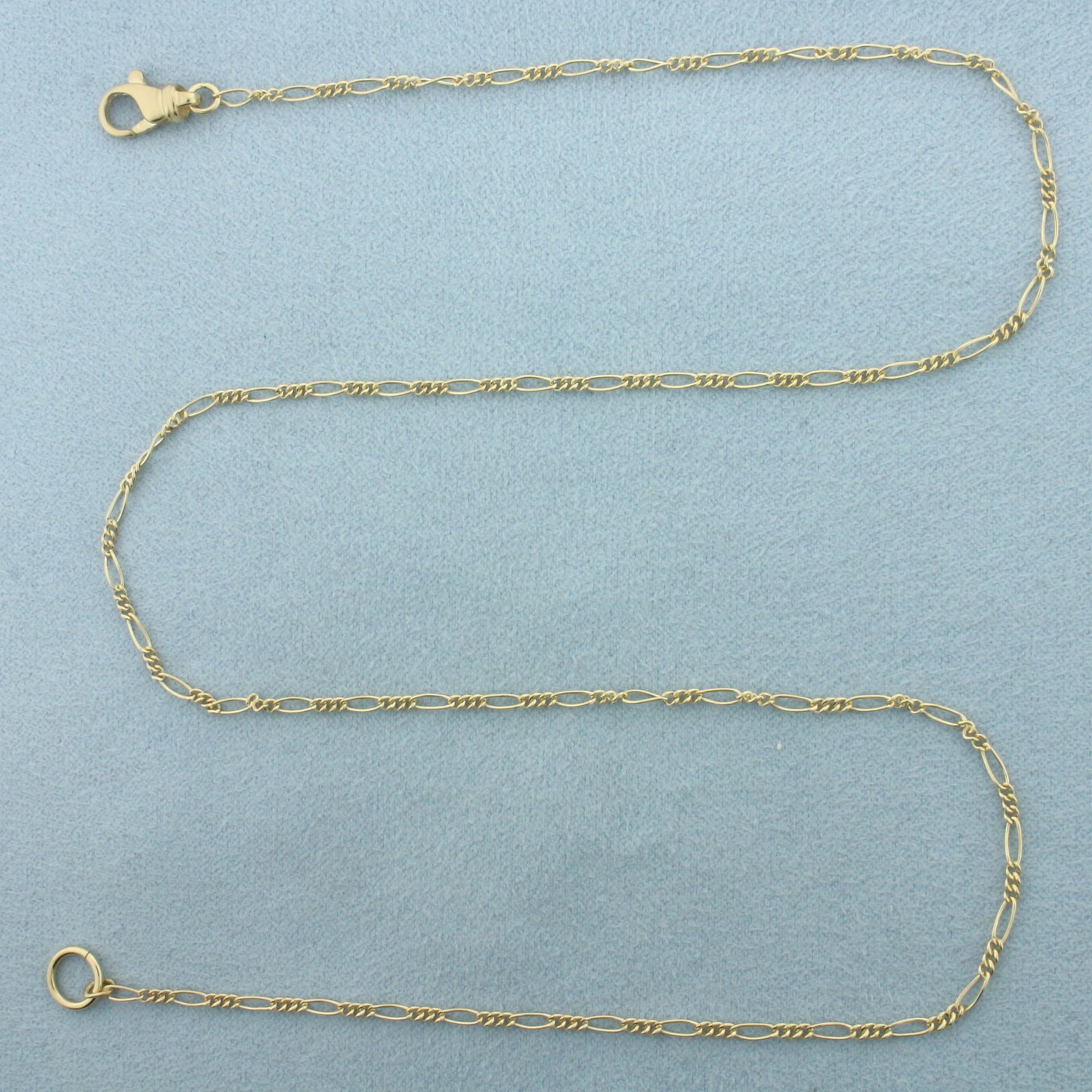 19 Inch Figaro Link Chain Necklace in 14k Yellow Gold: In 14k Yellow Gold. 19 inches long. 1.6mm wide. Lobster clasp. 3.3g.