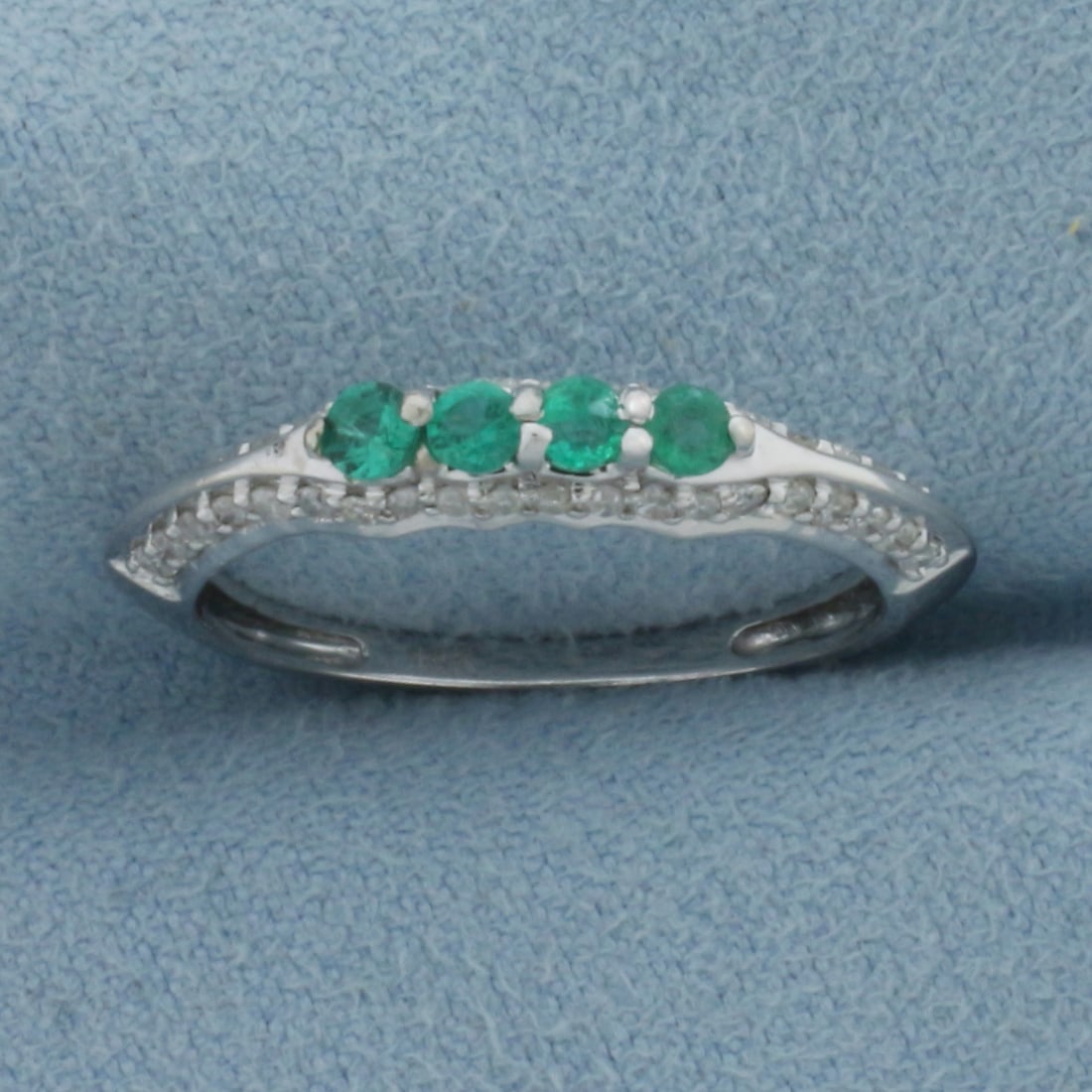 Emerald and Diamond Ring in 14k White Gold: In 14k White Gold. Contains four 2.2mm high quality natural Emerald gemstones with vibrant color and excellent clarity. Also contains forty high quality 1/2pt diamonds. 3.5mm wide at center. Size 7. 1