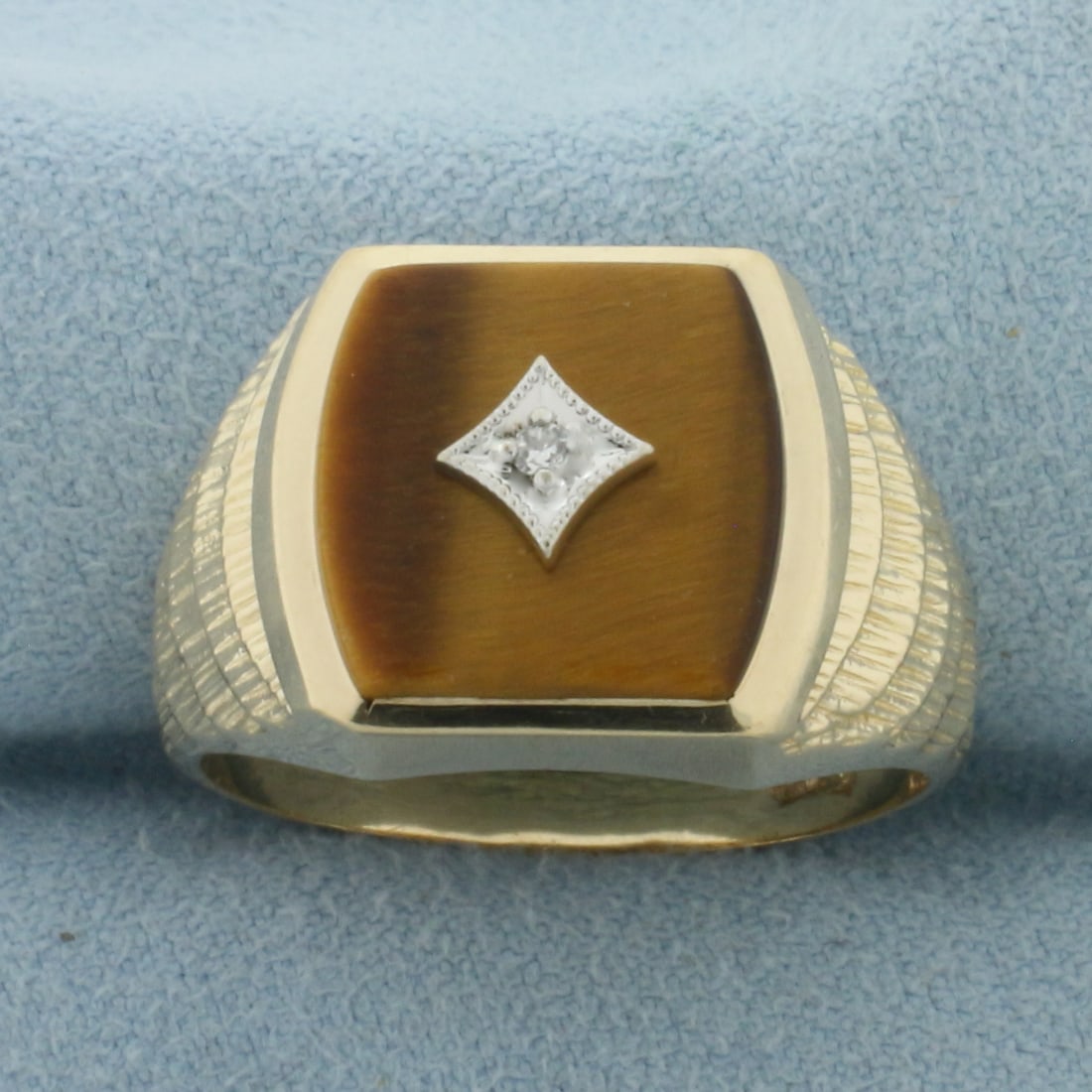 Mens Tiger Eye and Diamond Ring in 10k Yellow Gold: In 10k Yellow Gold. Contains one 13mm high quality Tiger's Eye gemstone. Also contains one .01ct high quality diamond. 14.5mm wide at top of ring. Size 11.5. 6.8g.