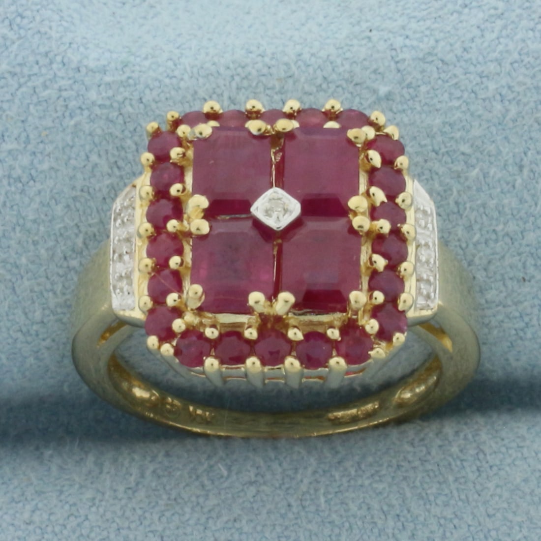 Ruby and Diamond Ring in 10k Yellow Gold: In 10k Yellow Gold. Contains four 5.2mm emerald and twenty-two 2mm round high quality natural Ruby gemstones with vibrant color and excellent clarity. Also contains seven high quality 1/2pt diamonds. 