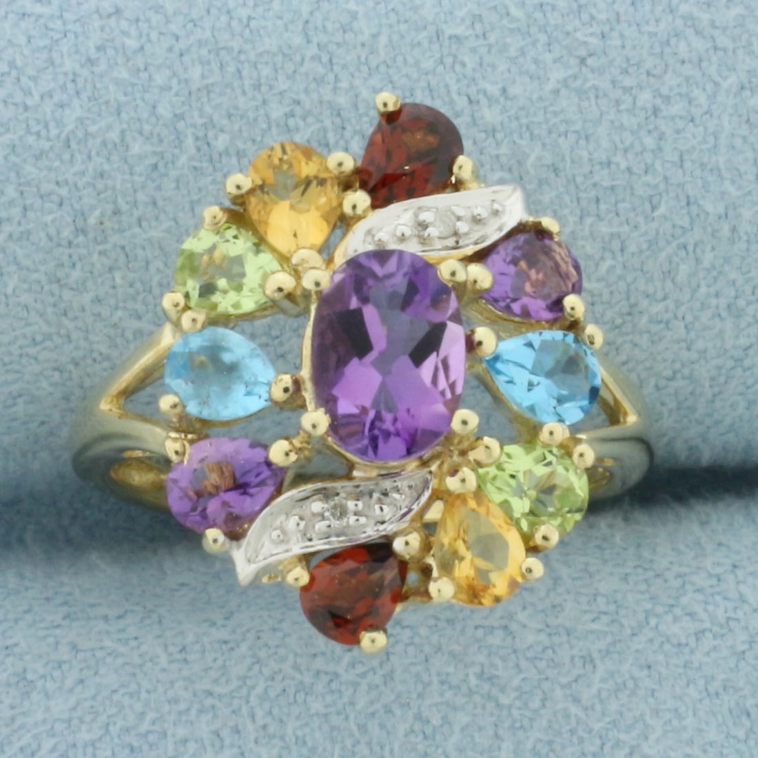 Rainbow Gemstone and Diamond Ring in 10K Yellow Gold: In 10k yellow gold. 18.6mm wide at top center. Contains one 7mm amethyst and two of 4mm garnet, citrine, amethyst, peridot, and blue topaz high quality natural gemstones, all with vibrant color and ex