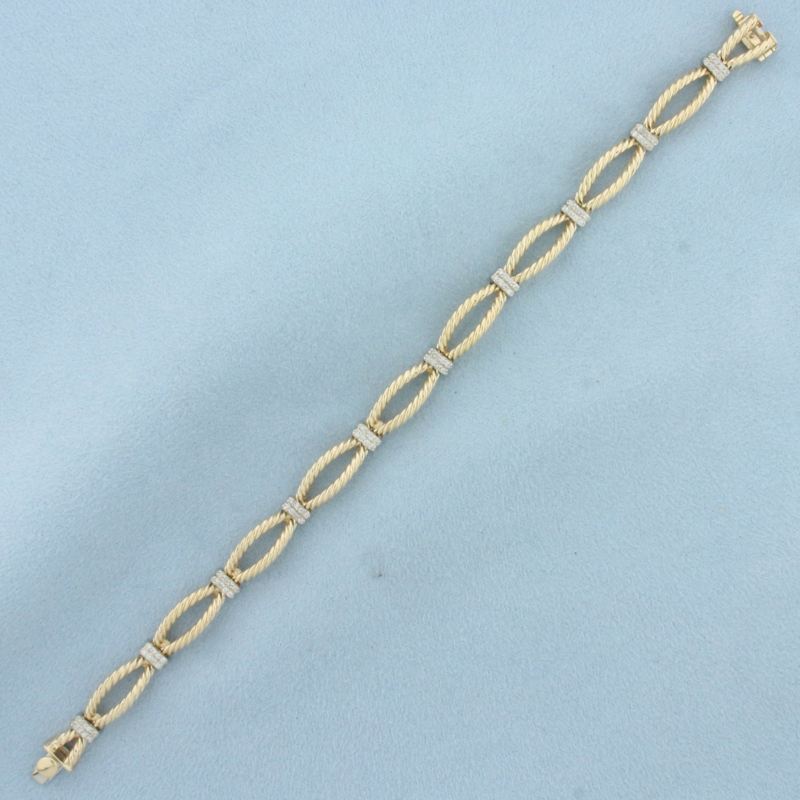 Designer Diamond Rope Design Bracelet in 14k Yellow gold: In 14k yellow gold. 7.5 inches long and 7mm wide. Contains 80 high quality .01ct diamonds, SI clarity/H color. Concealed side clasp with underswing safety latch. 21.8g.