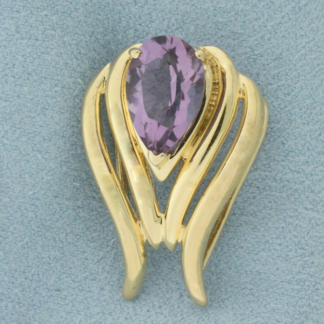 Amethyst Slide Pendant in 14k Yellow Gold: In 14k yellow gold. Measures 1 inch long by 3/4 inch wide. Contains one 12.5mm high quality natural Amethyst gemstone, approximately 3ct, with bright color and excellent clarity. Can accommodate most 