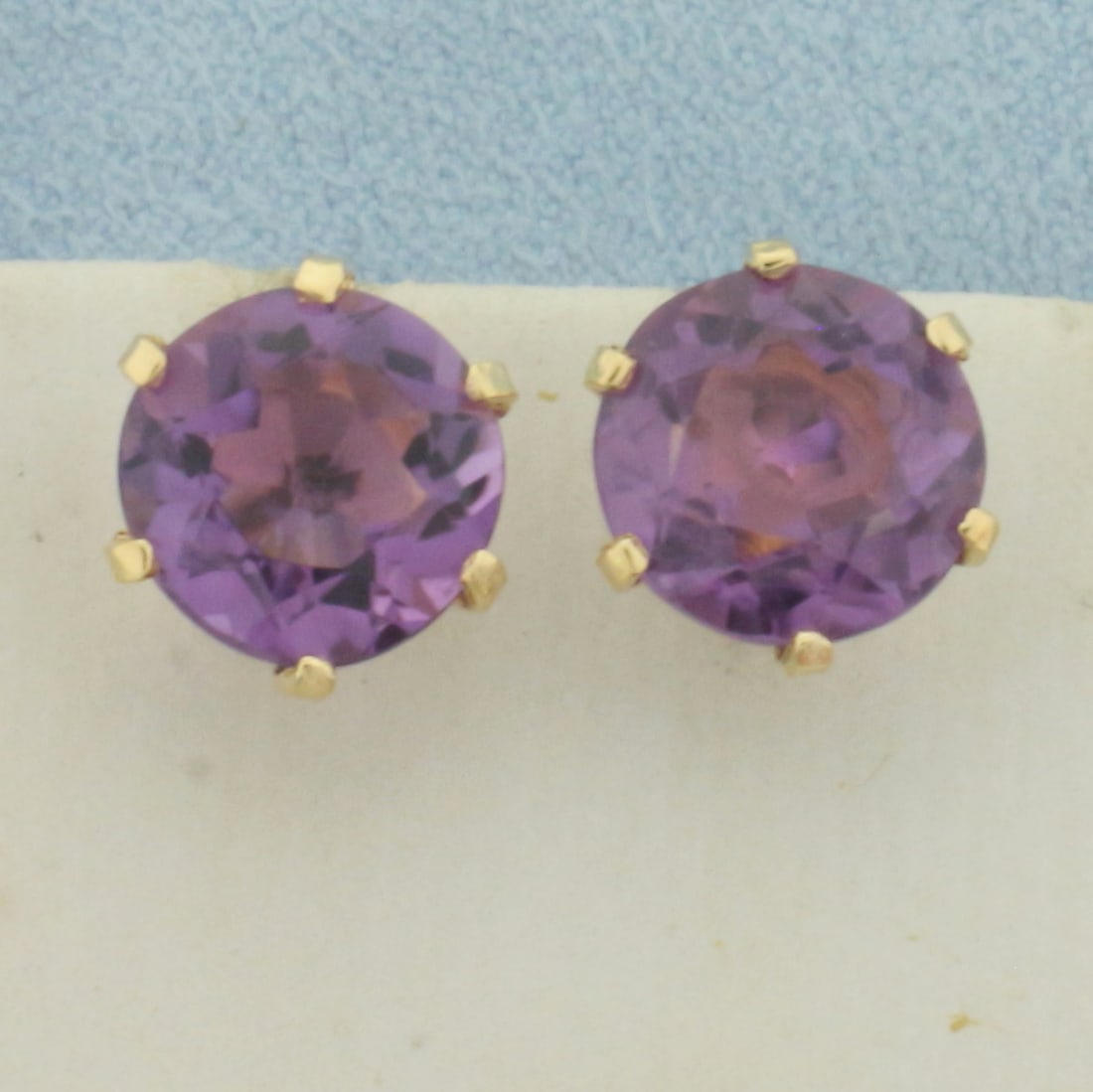 Amethyst Stud Earrings in 14k Yellow Gold: In 14k Yellow Gold. Contains two 9mm high quality natural Amethyst gemstones, approximately 5ct TW, with vibrant color and excellent clarity. Friction backs. 2.5g.