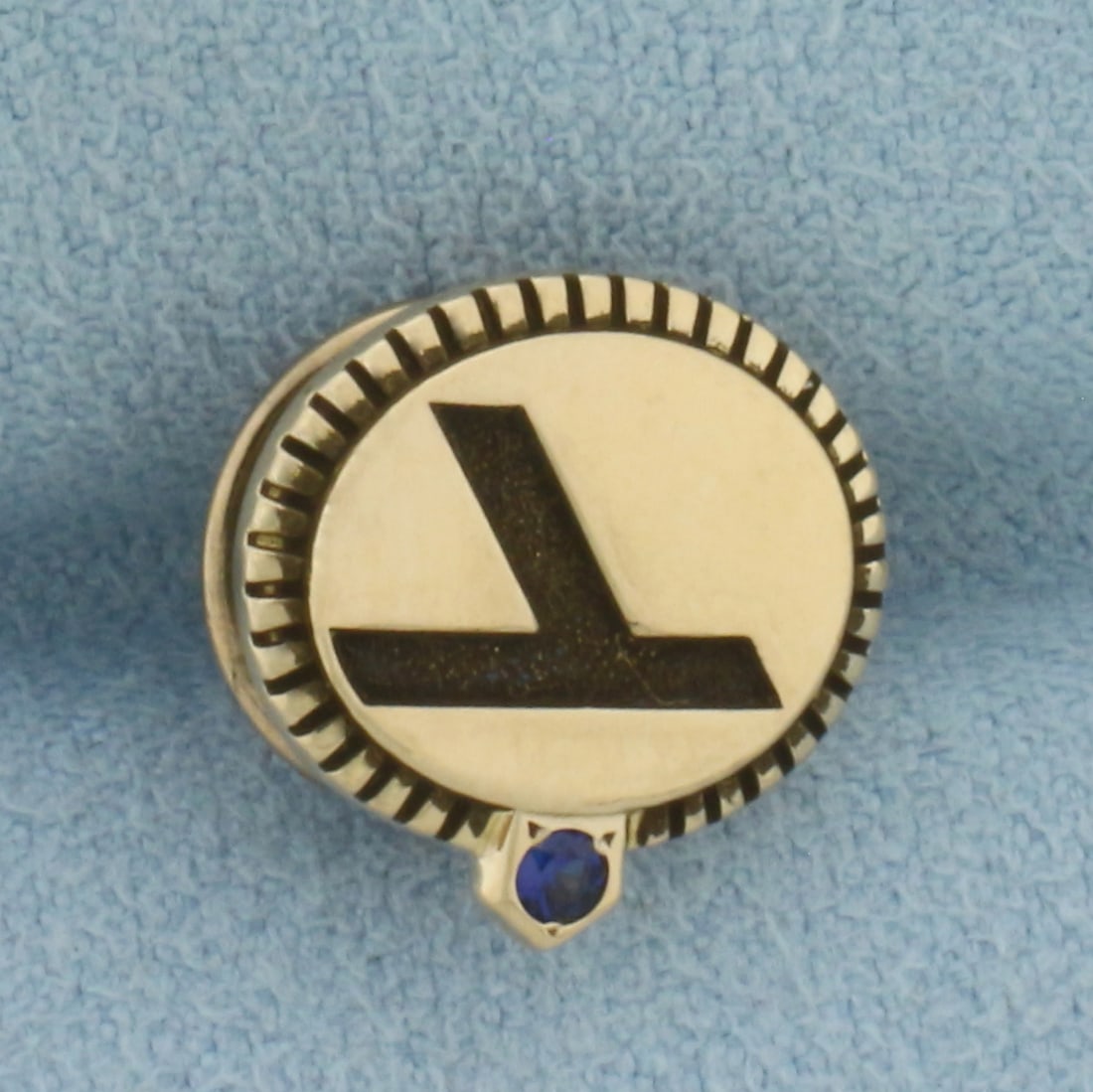Vintage Eastern Airlines Pin in 10k Yellow Gold: In 10k Yellow Gold, back is gold plated. Contains one 2mm high quality Sapphire gemstone with vibrant color. 1/2 inch wide. 1/2 inch tall. 3.6g.