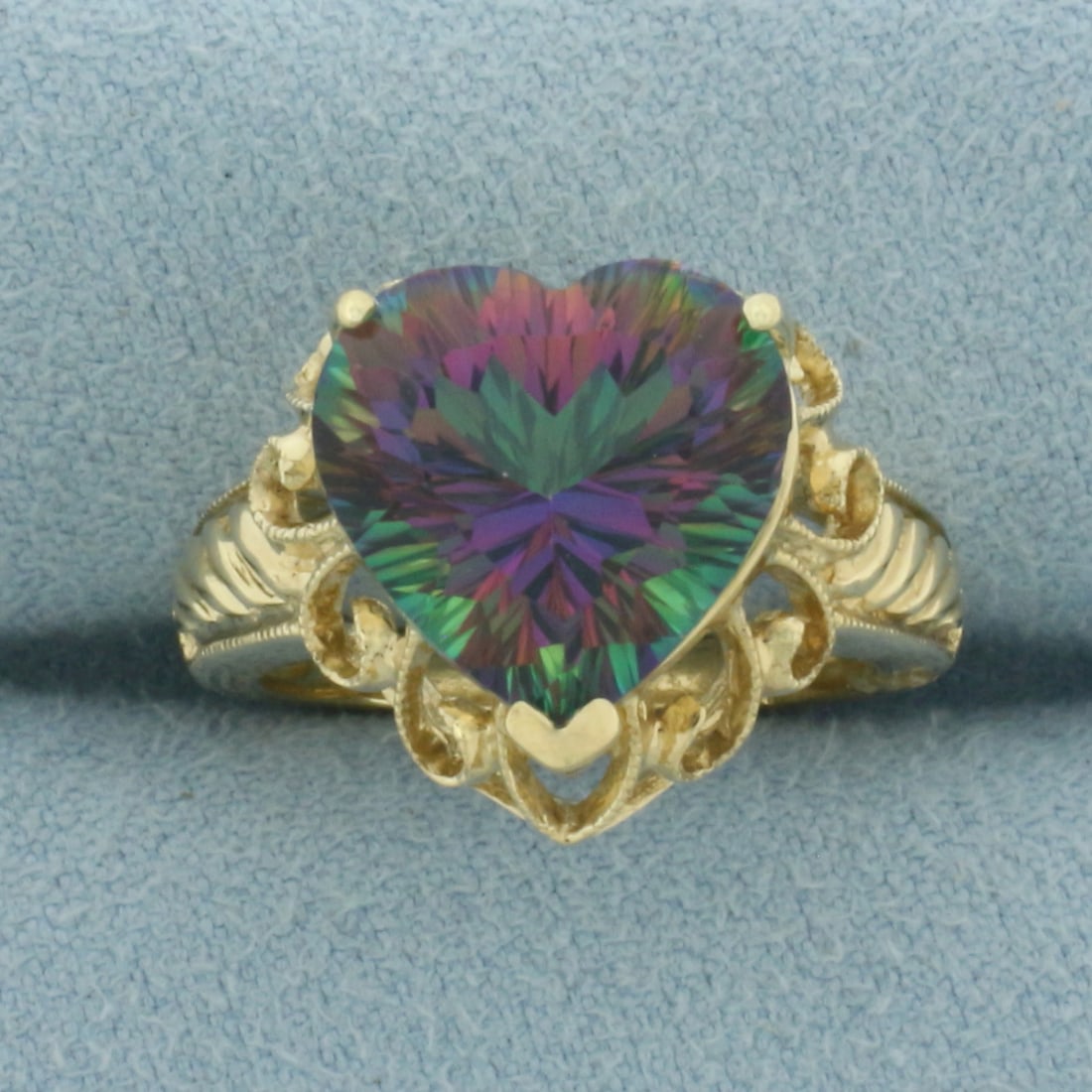Heart Mystic Topaz Ring in 10k Yellow Gold: In 10k Yellow Gold. Contains one 12mm high quality heart cut Mystic Topaz gemstone,with vibrant color and excellent clarity. Size 6. 5.3g.