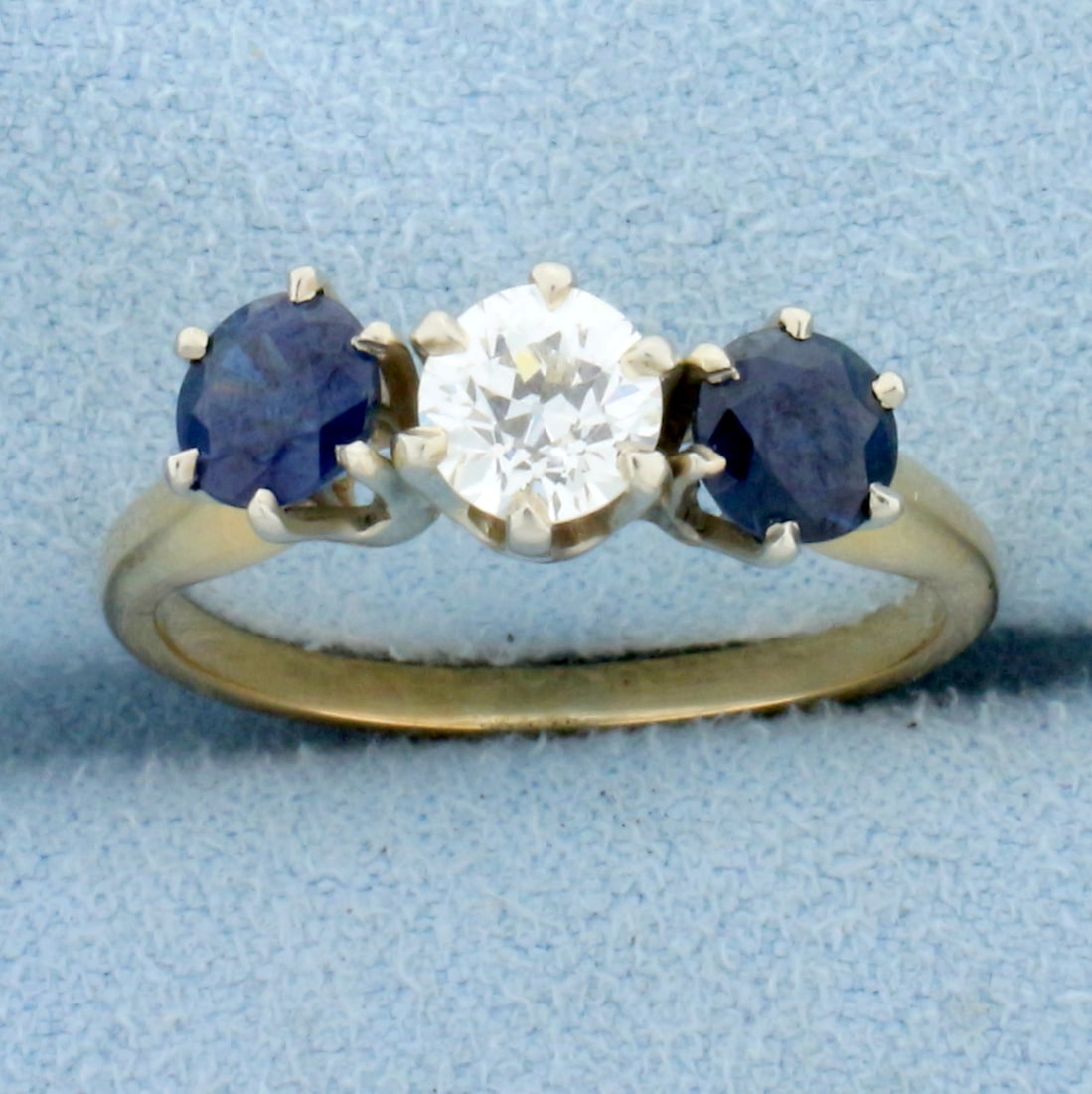 Antique Three Stone Sapphire and Diamond Ring in 14K Yellow and White Gold: In 14K Yellow Gold with white gold prongss. Contains two high quality natural 5mm AAA quality Sapphire gemstones, .9ct TW, with intense blue color and excellent clarity. Also contains a high quality .