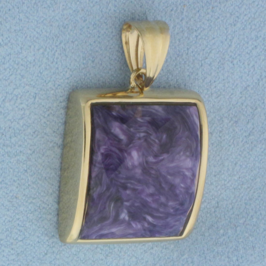Charoite Pendant in 14k Yellow Gold: In 14k Yellow Gold. Contains one 18x16mm high quality large faceted natural Charoite gemstone with vibrant color. 1 1/8 inch long. 3/4 inch wide. 6.3g.