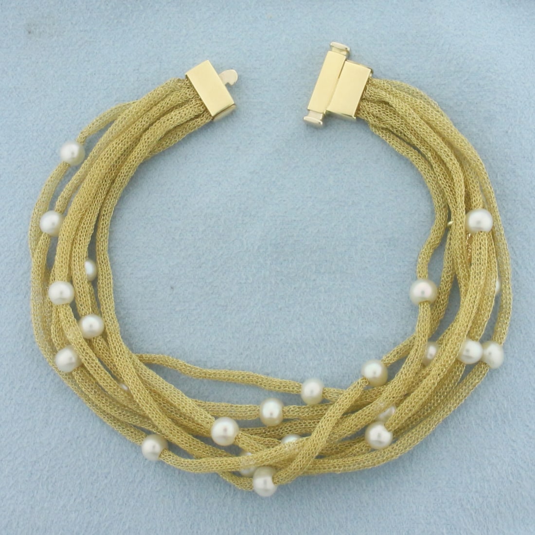 Italian Designer Soft Gold Mesh Cultured Pearl Bracelet in 14k Yellow Gold: In 14k Yellow Gold. Contains twenty-four 4.3-4.7mm high quality Cultured Pearls with high luster. 7 1/4 inches long. 2.5mm wide each. Italian made. Push clasp. 7.5g.