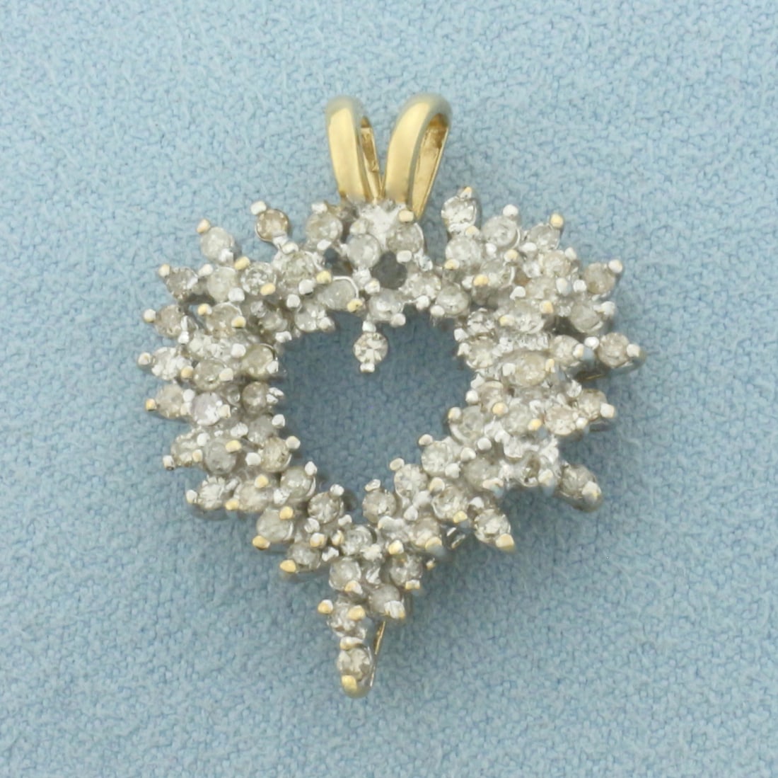Diamond Heart Pendant in 10k Yellow Gold: In 10k Yellow Gold. Contains seventy-two high quality diamonds, 1ct TW. 1 inch long. 7/8 inch wide. 4.8g.