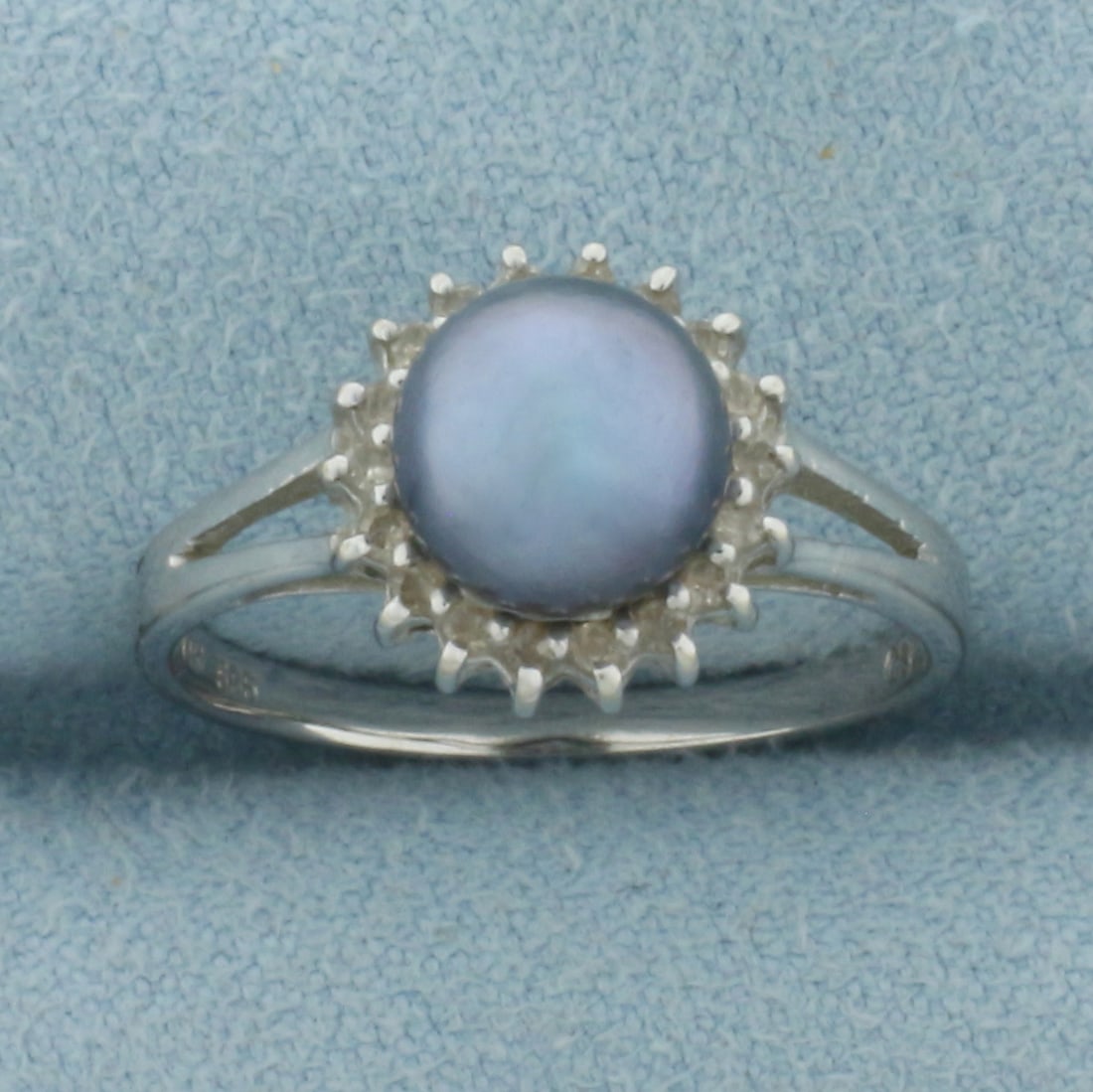 Tahitian Pearl and Diamond Halo Ring in 14k White Gold: In 14k White Gold. Contains one 7.3mm high quality Tahitian Pearl with high luster and beautiful peacock undertone. Also contains eighteen high quality 1/2pt diamonds. 10.5mm wide at top of ring. Size