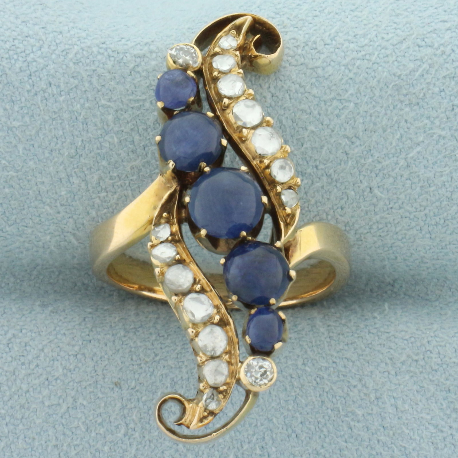 Antique Old Cut Diamond and Sapphire Ring in 14k Yellow Gold: In 14k yellow gold. Contains five high quality natural cabochon sapphire gemstones ranging from 3mm to 5.5mm each with intense sapphire blue color. Also contains two .06ct high quality Old European